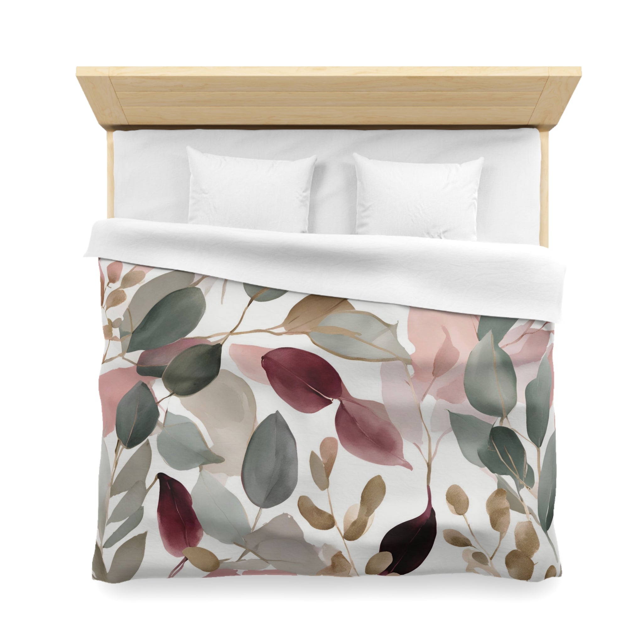 a bed with a white comforter and a colorful floral print on the bedspread.