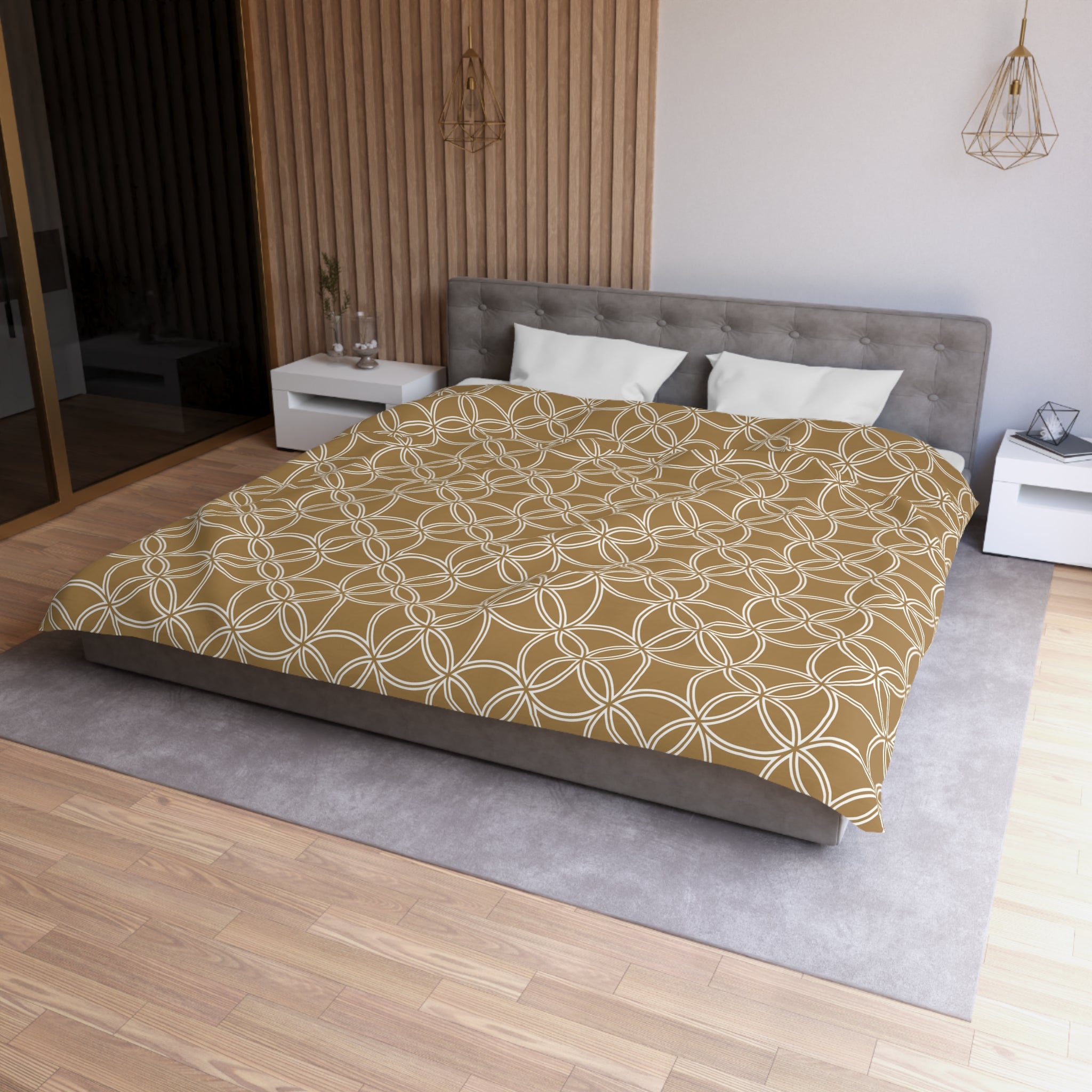 a modern bedroom with a large bed, a gray headboard, and a wooden floor. The bed is covered in a patterned comforter, and there are two white pillows on it. The room has a minimalist and clean design, with a gray wall and a wooden paneled wall. There are also two white nightstands on either side of the bed, and a pendant light hanging above it.
