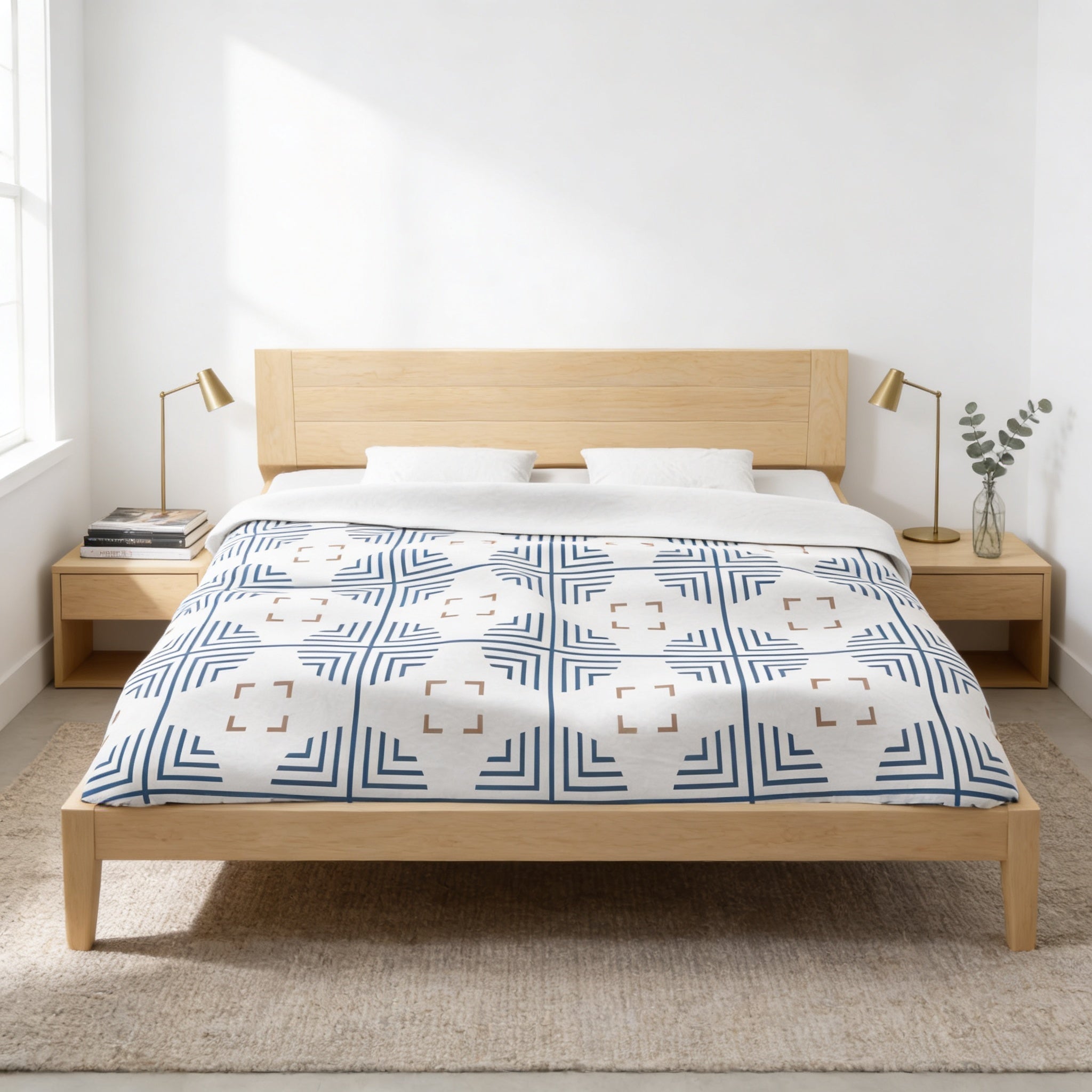 a modern bedroom with a wooden bed frame, a white and blue patterned comforter, and two nightstands with lamps.