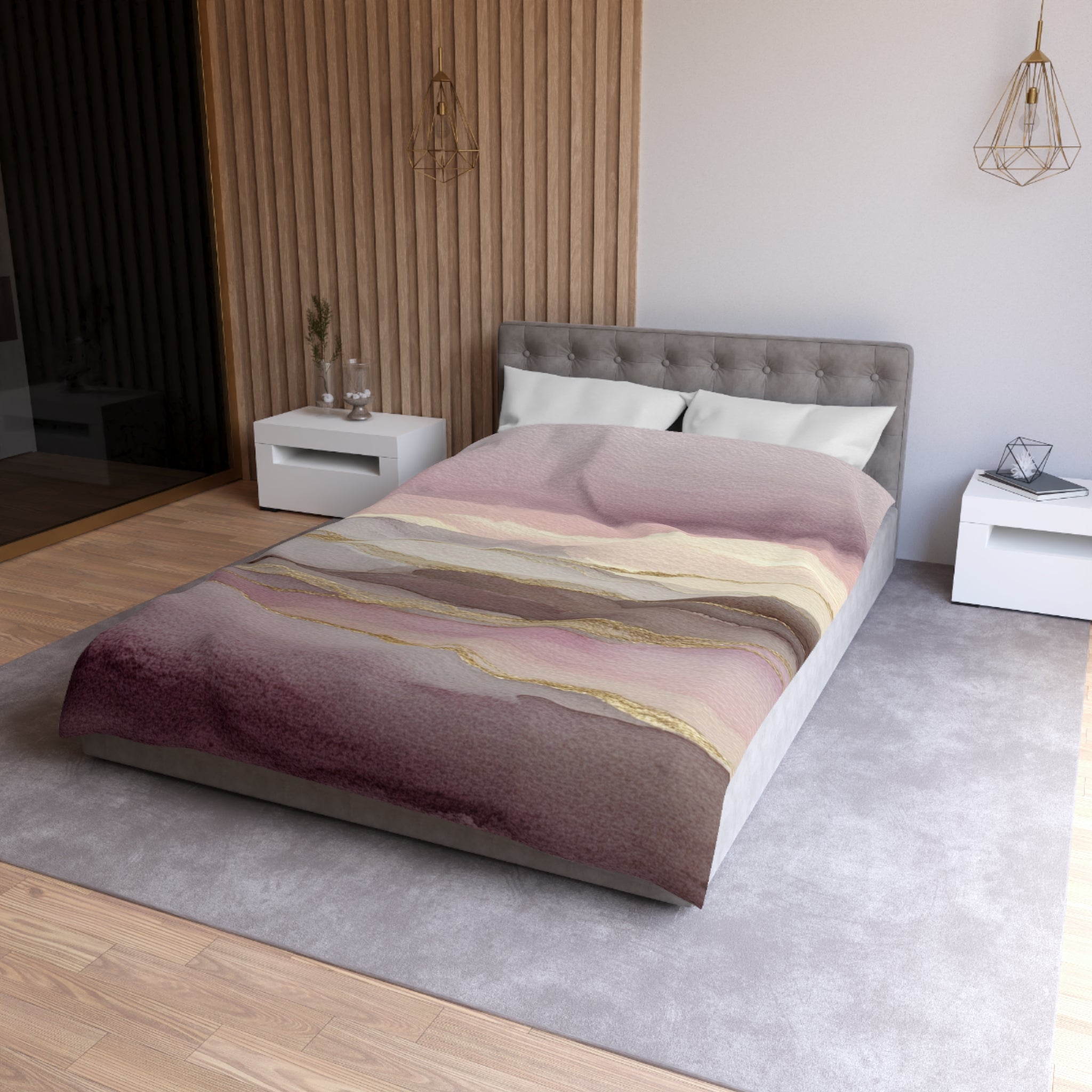 a modern bedroom with a large bed, a gray headboard, and a colorful abstract patterned bedspread. The room has a neutral color scheme with white walls and a gray carpet. There are two nightstands on either side of the bed, and a pendant light hangs above the bed.