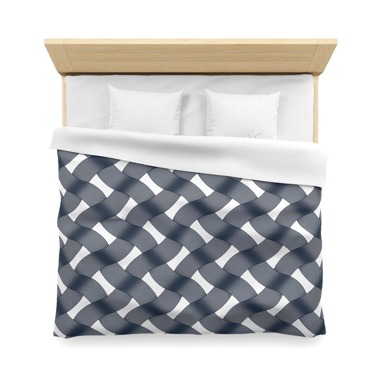 a neatly made bed with a blue and white patterned comforter and two white pillows.