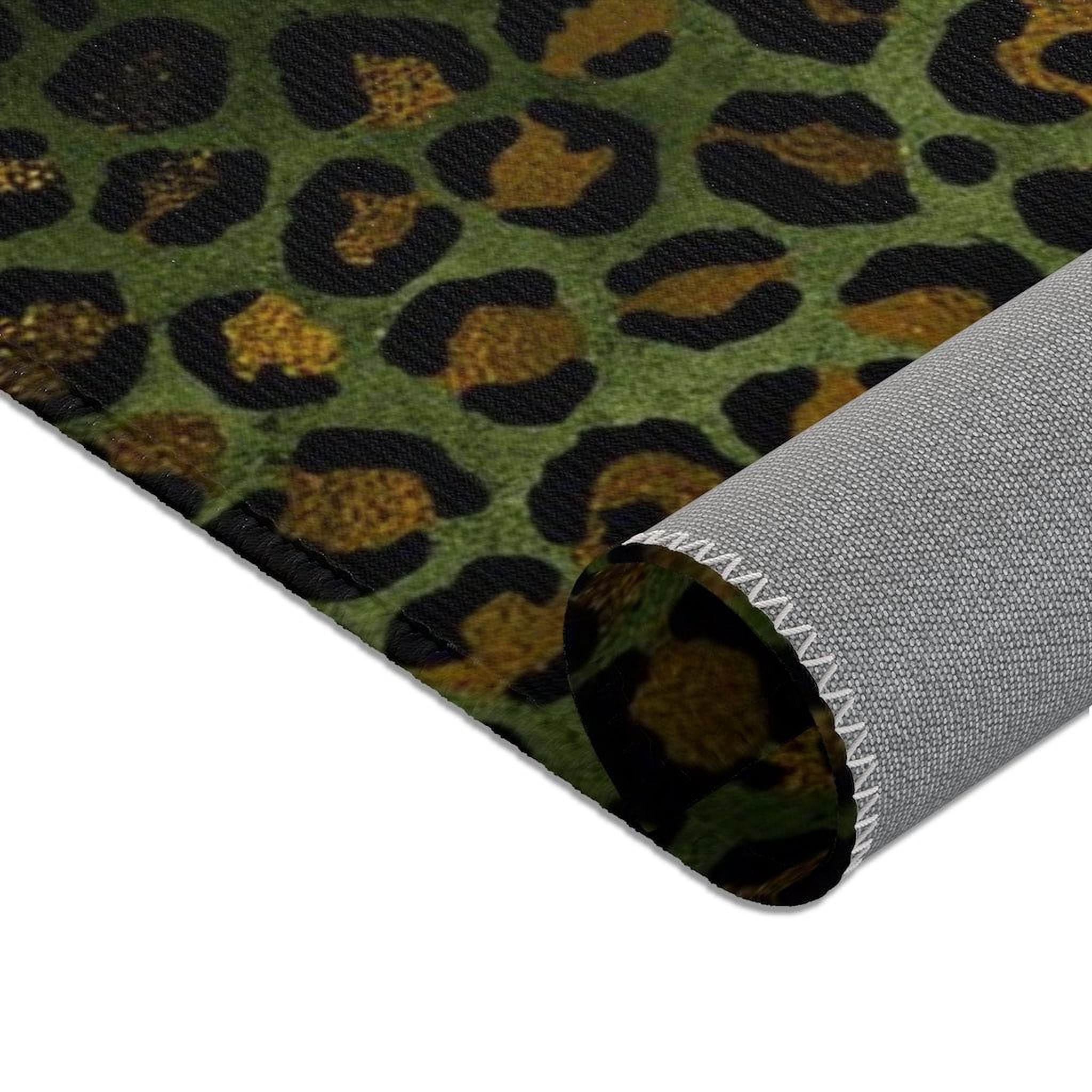 a close-up view of a textured surface with a repeating pattern of leopard-like shapes in shades of green and black.