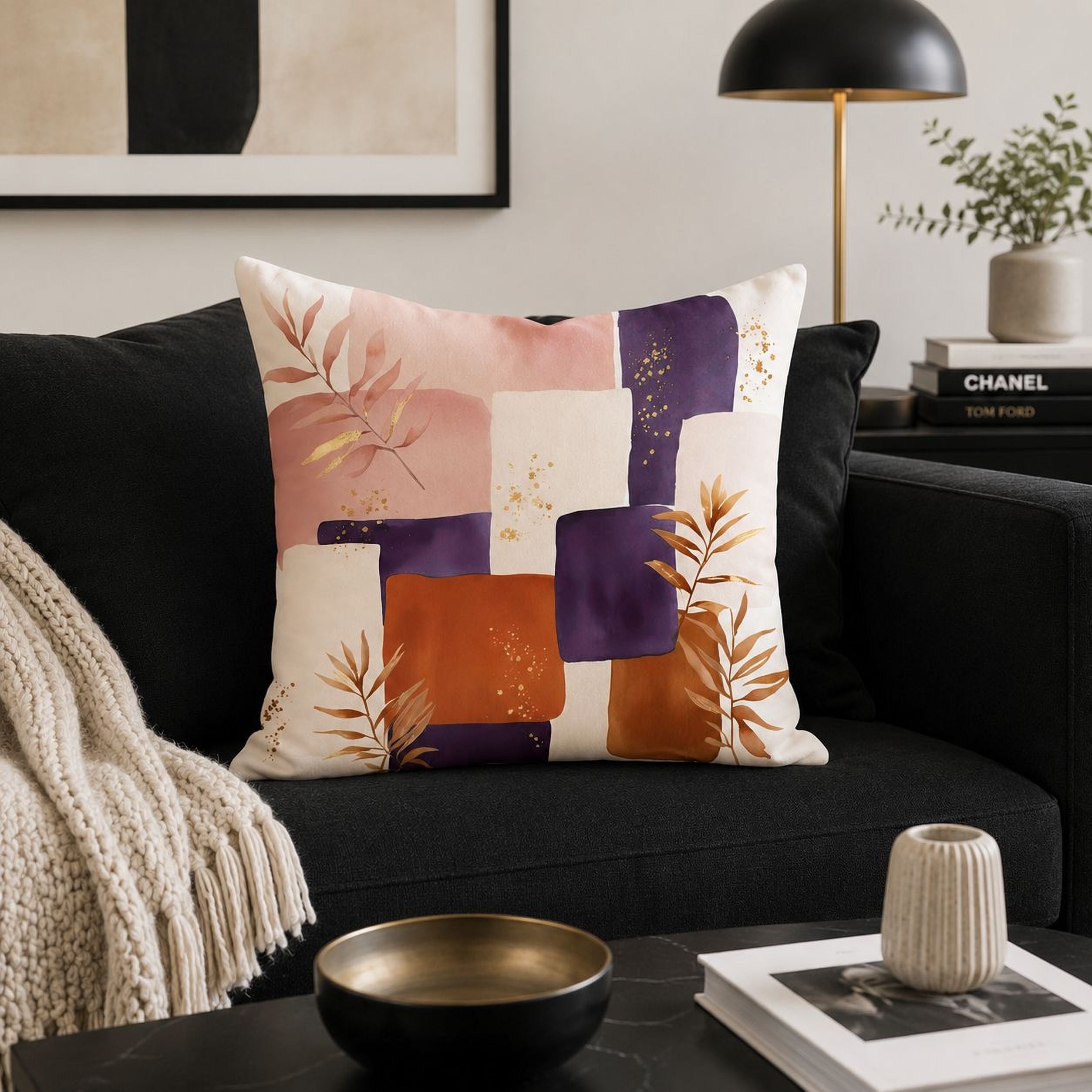 a living room with a black couch, a decorative throw pillow with a colorful abstract design, and a black lamp on a side table.