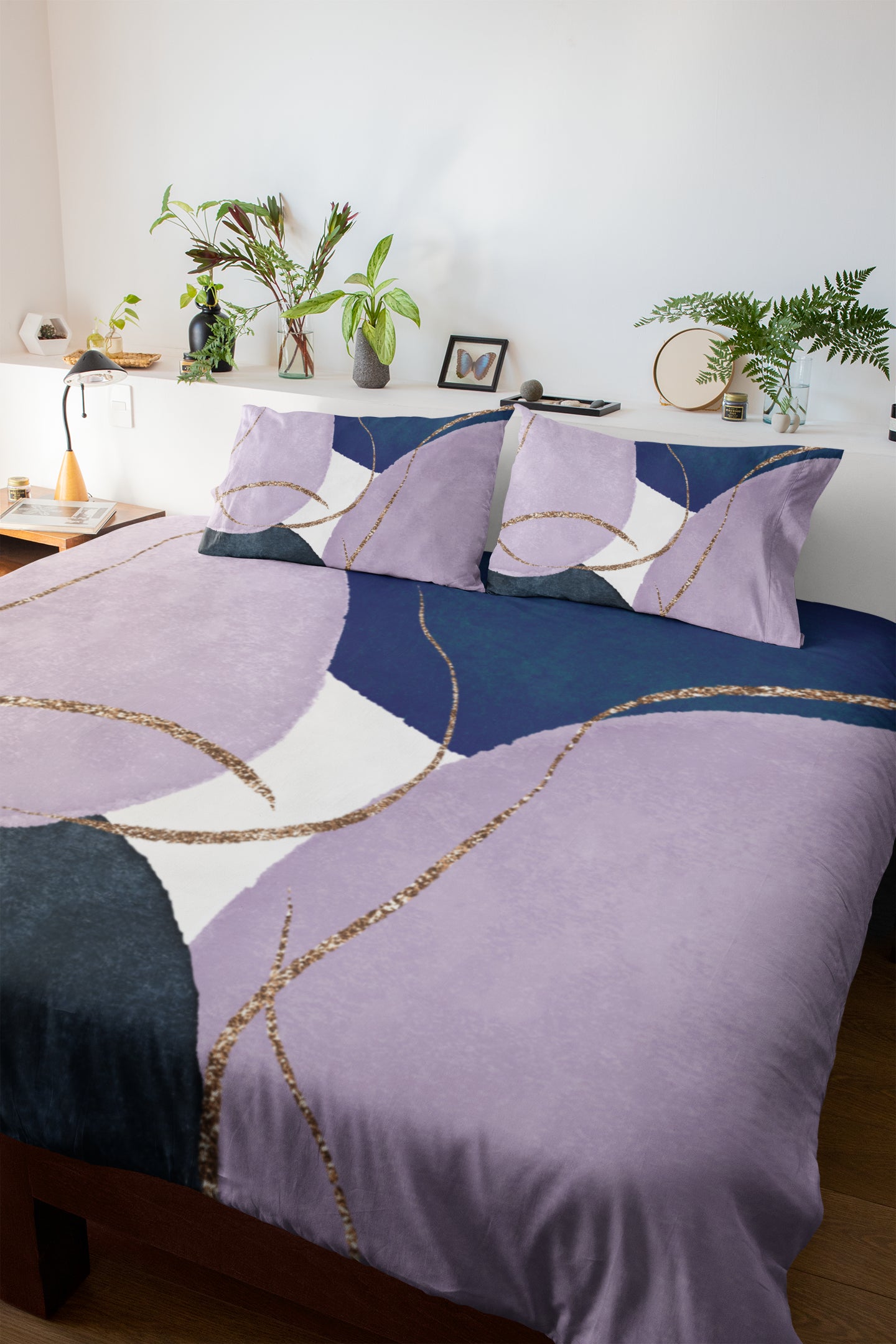 a bed with a purple comforter and pillows