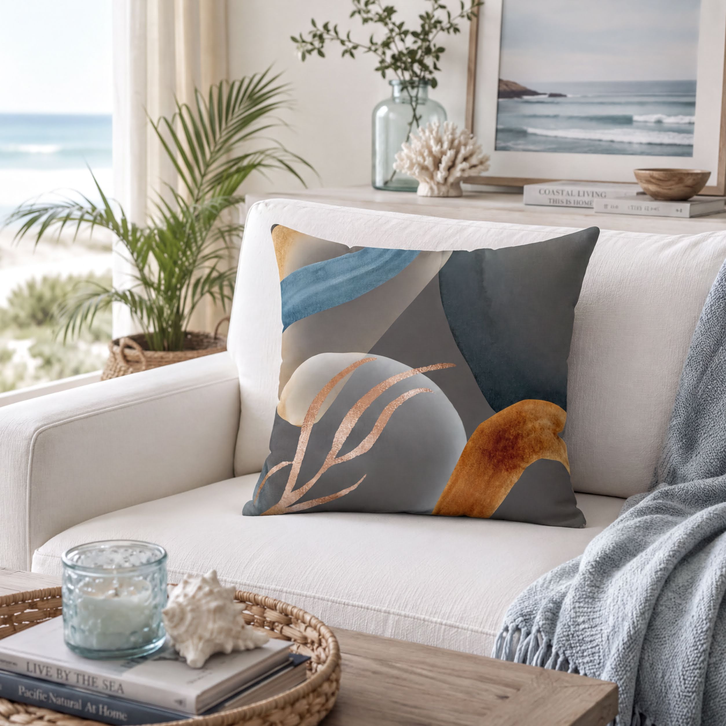 a cozy living room with a white sofa, a decorative pillow, and a framed picture of the ocean. The room also includes a potted plant, a vase with flowers, and a bookshelf with books.
