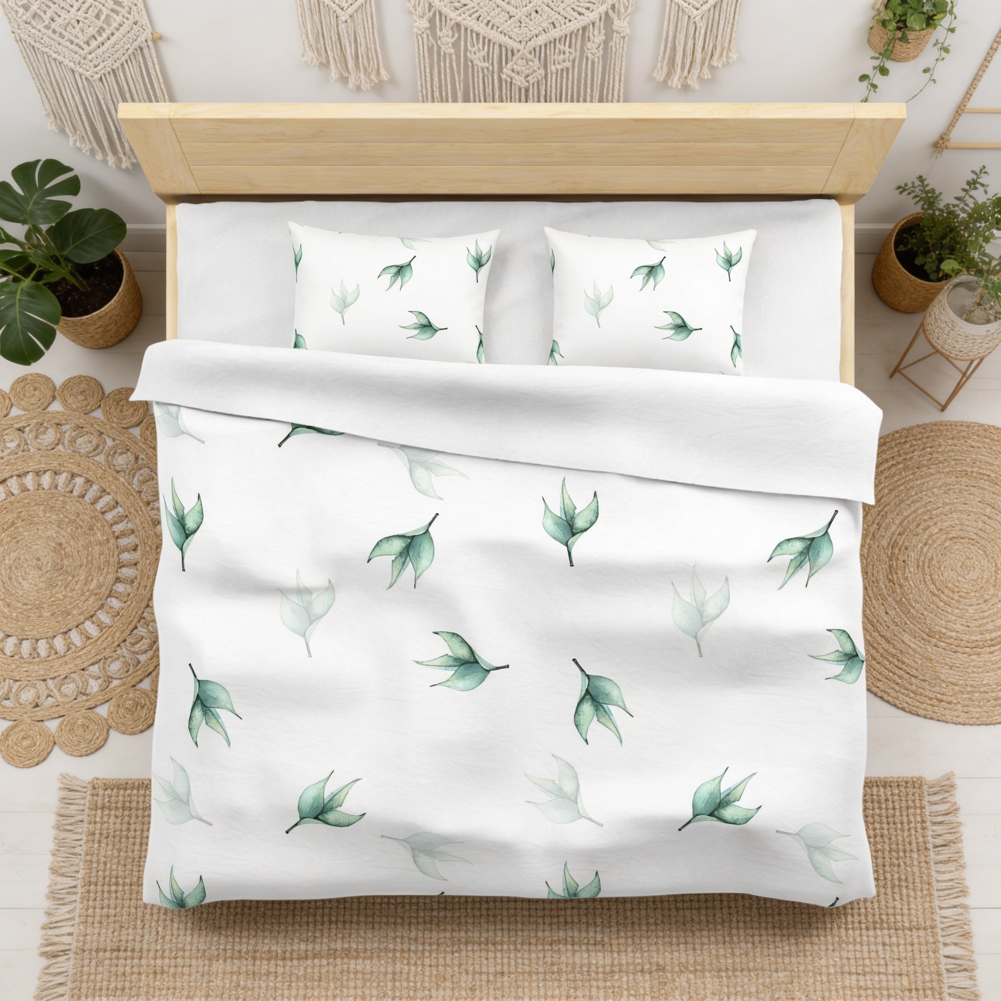 a bedroom with a bed featuring a white comforter and pillows decorated with a leaf pattern. The bed is surrounded by various plants and decor elements, creating a cozy and natural atmosphere.