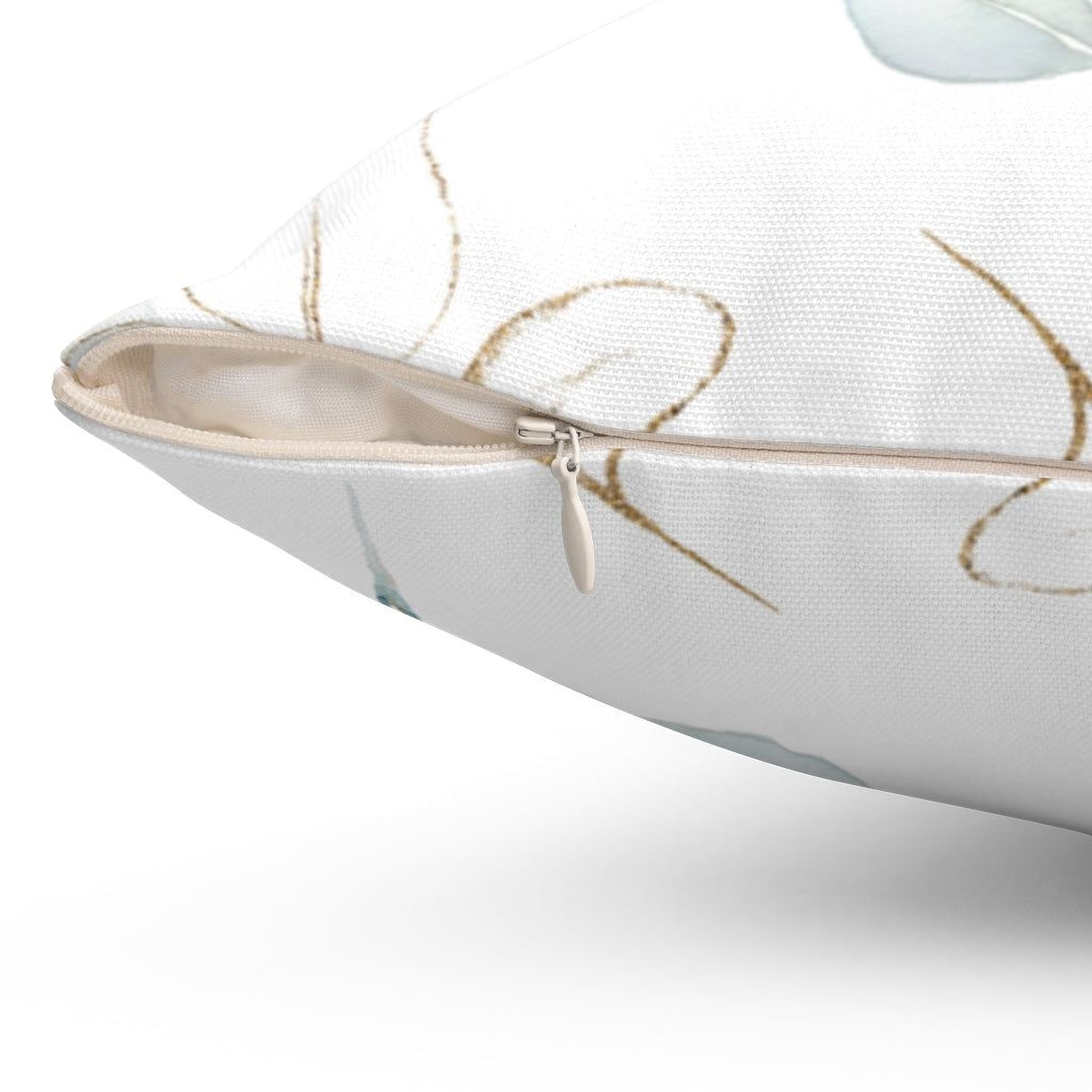 a close-up view of a white pillow with a zipper pull and a patterned design on it.