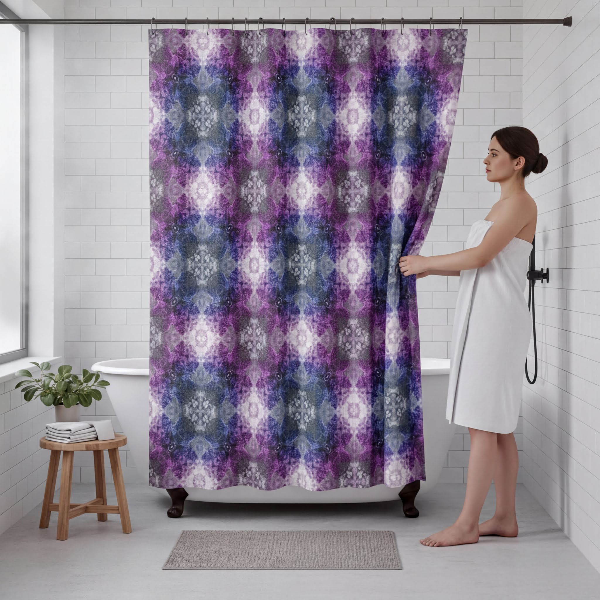 A woman stands in a bathroom, holding a purple and blue patterned shower curtain. The bathroom has white tiled walls, a bathtub, and a wooden stool.