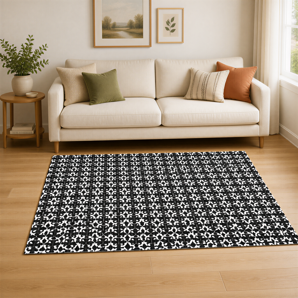 a cozy living room with a white sofa, a black and white patterned rug, and a potted plant on a side table.