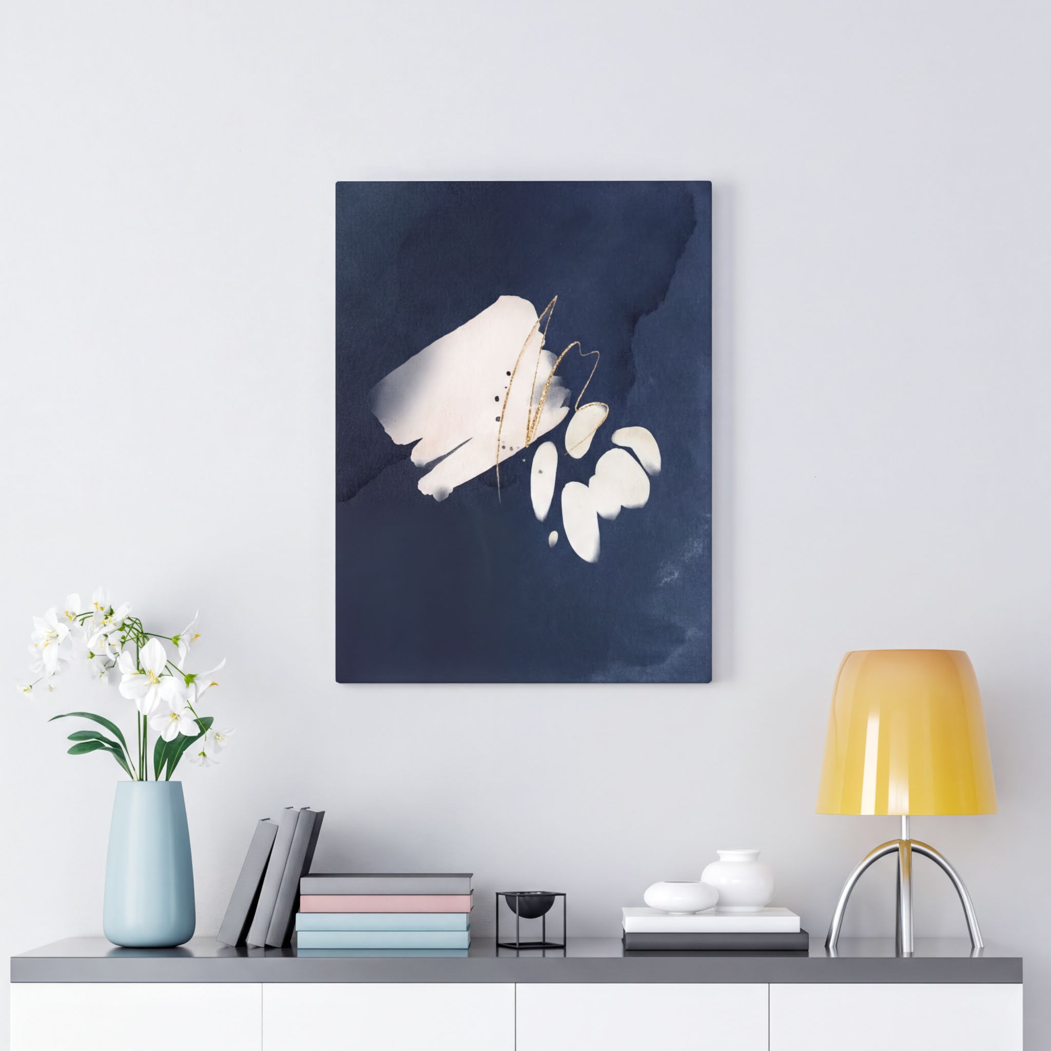 Navy blue, cream and white abstract wall canvas art in a bedroom setting