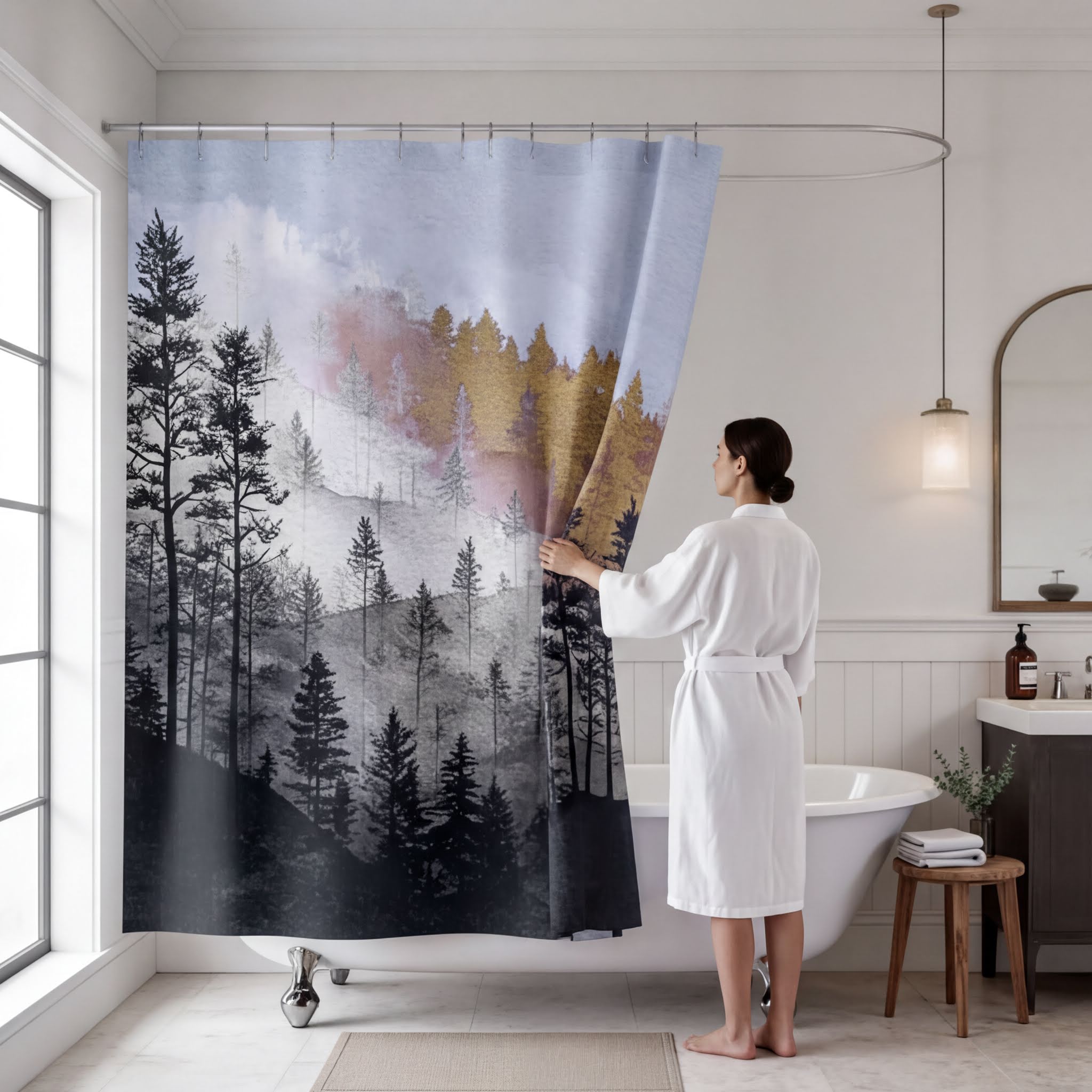 A woman in a white bathrobe stands in a bathroom, holding a shower curtain with a forest scene printed on it.