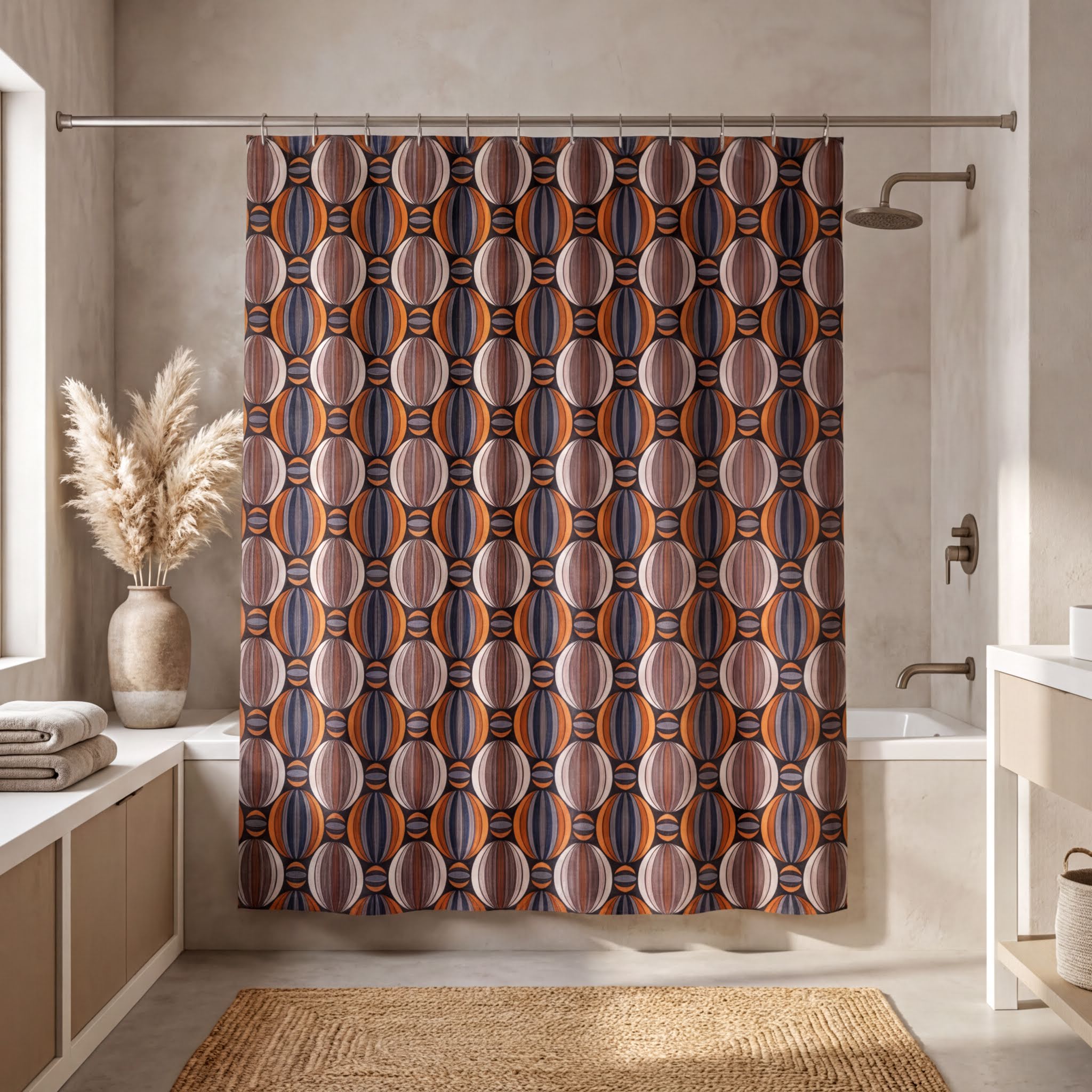 a bathroom with a shower curtain adorned with a geometric pattern in shades of orange, blue, and brown. The shower curtain is hanging from a rod, and there is a vase with dried flowers placed on a shelf next to the shower. The bathroom also includes a sink and a rug on the floor.