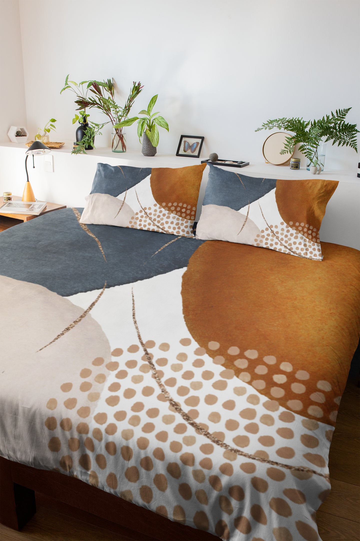 a bed with a brown and white comforter and pillows