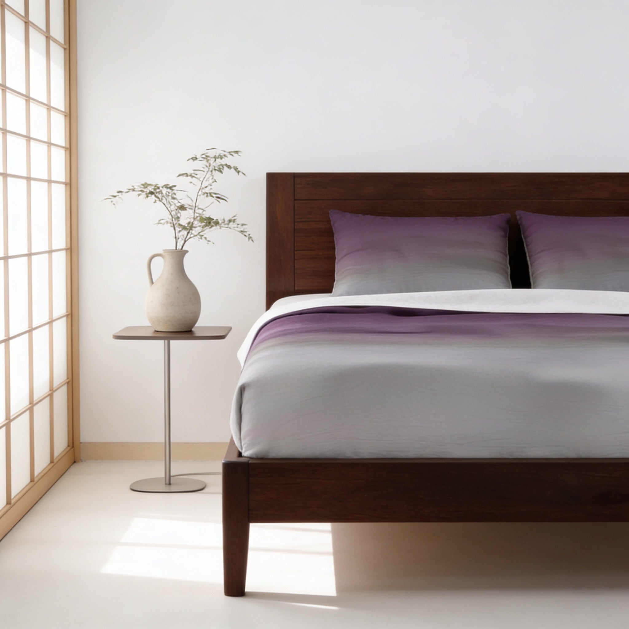a serene and modern bedroom with a wooden bed frame, a white vase with greenery, and a wooden nightstand.