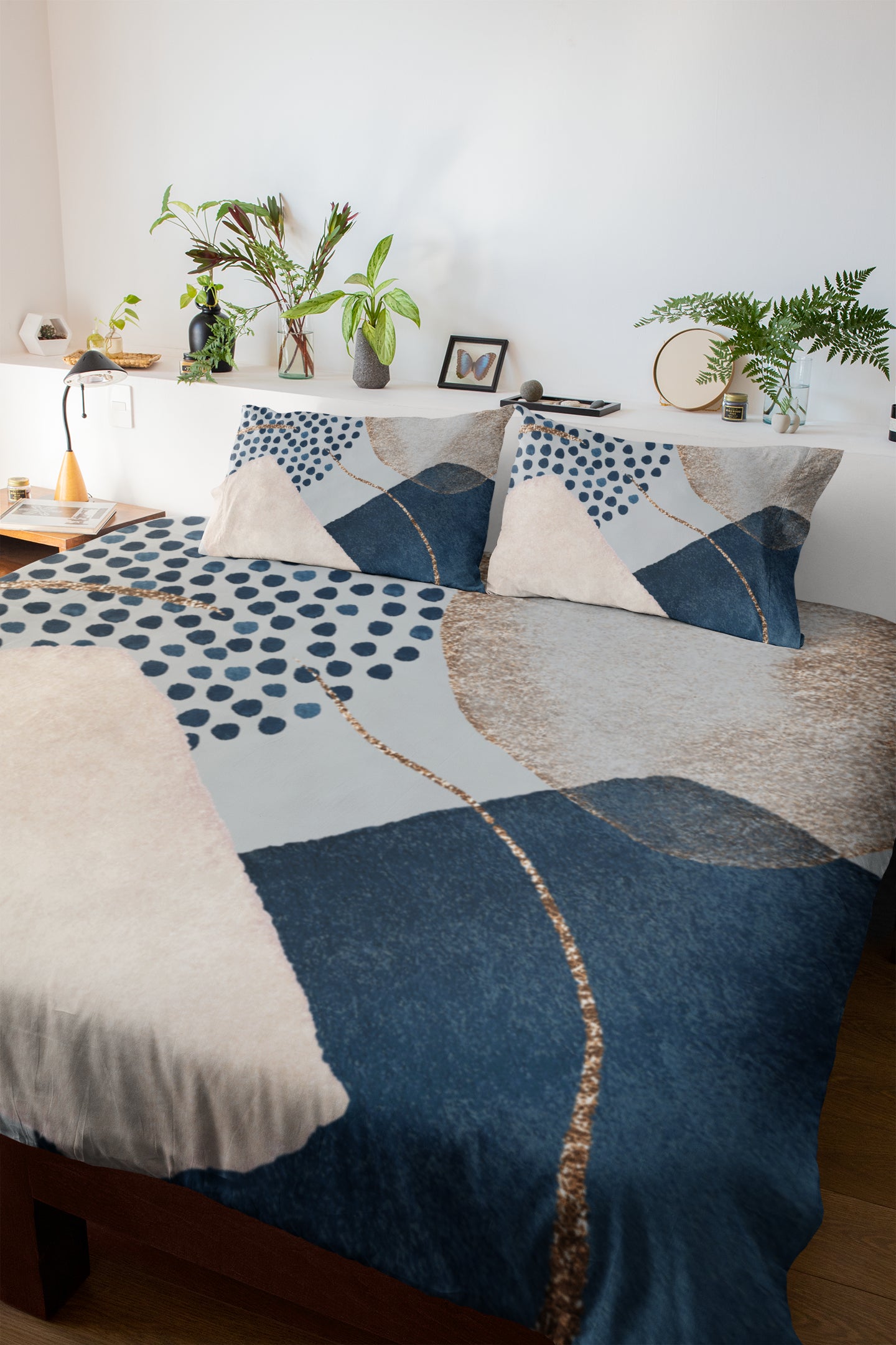 a bed with a blue and white comforter and pillows