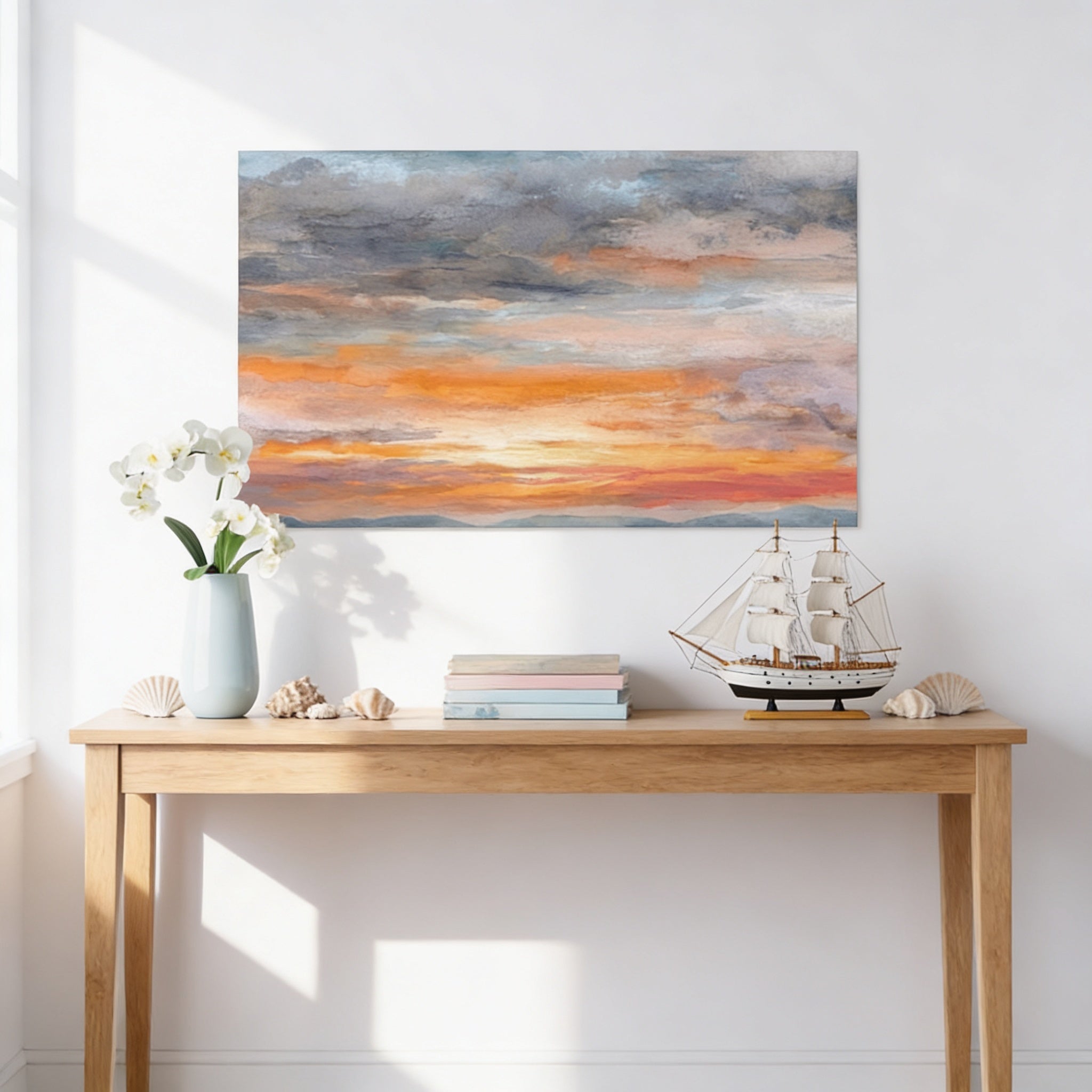 a wooden table with a vase of white flowers, a stack of books, and a small model ship, all set against a backdrop of a painting depicting a sunset over the ocean.