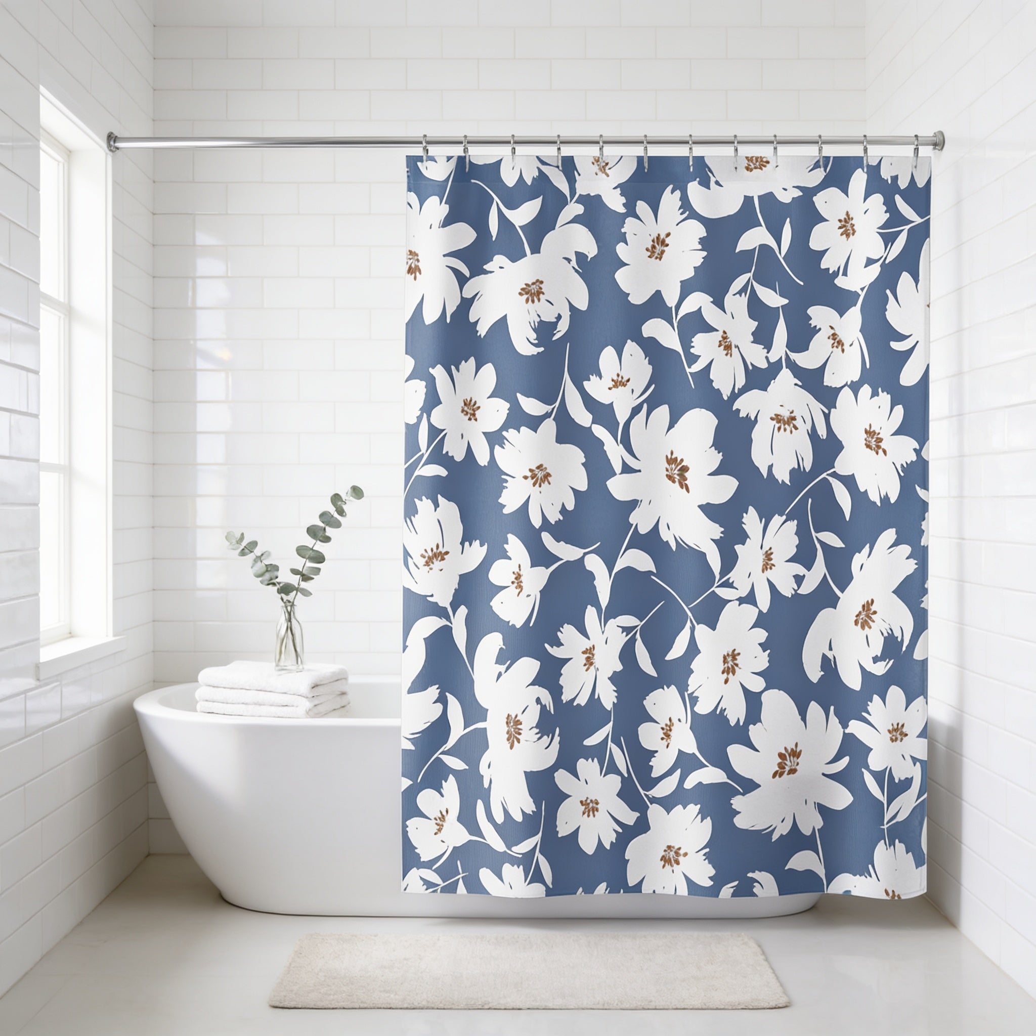 a bathroom with a white bathtub, a blue floral shower curtain, and a small plant in a vase.