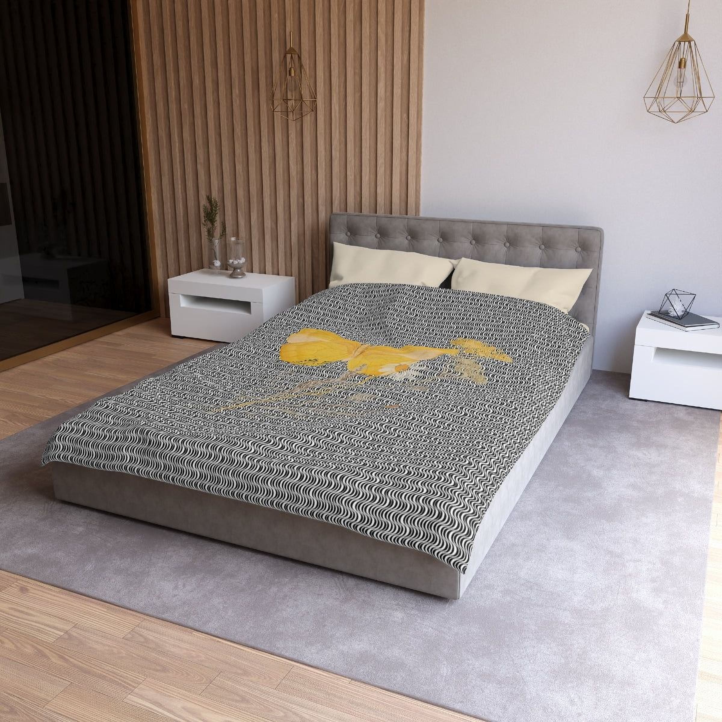 a modern bedroom with a gray tufted headboard, a gray bedspread with a yellow and black geometric pattern, and white nightstands on either side of the bed.