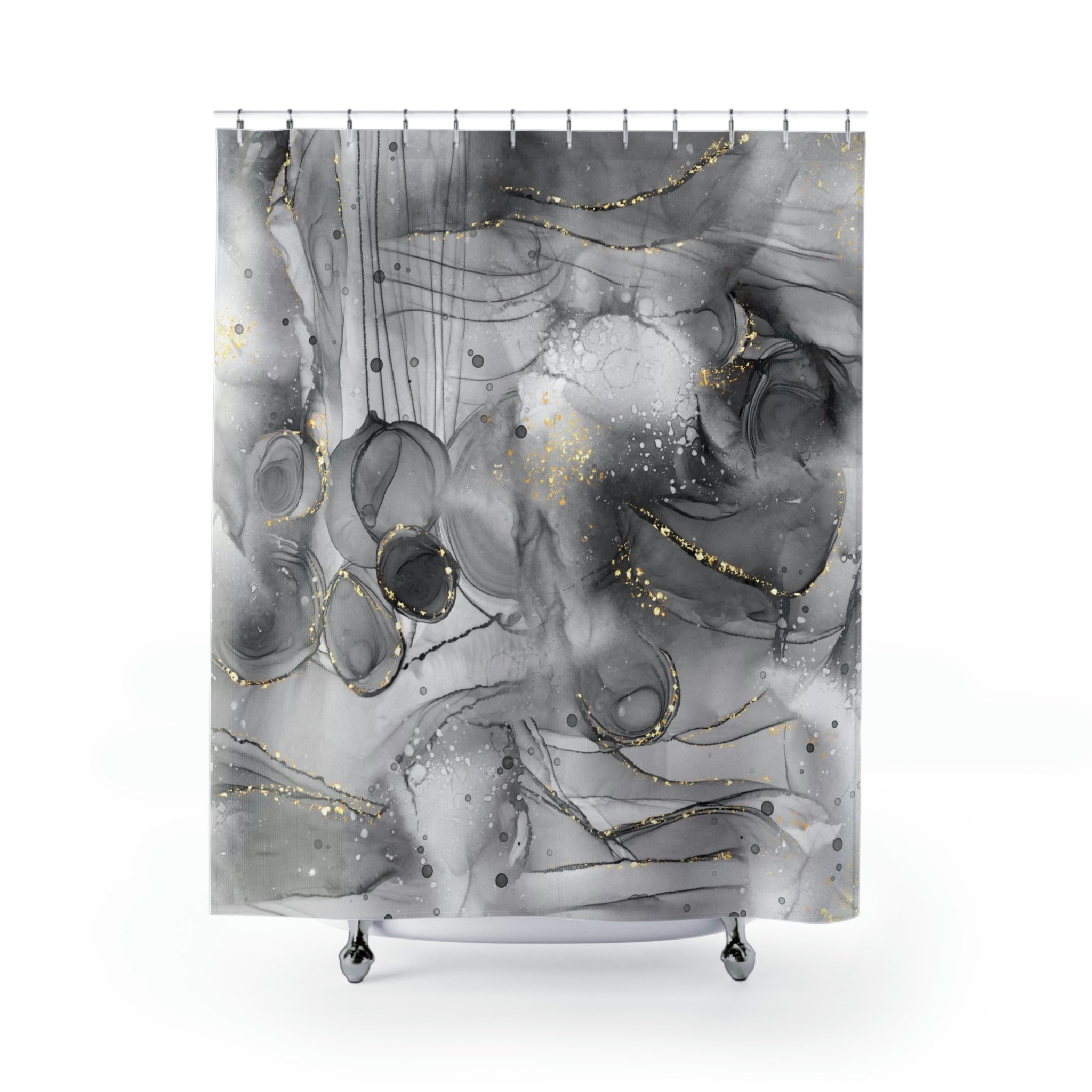 a black and white shower curtain with gold dots